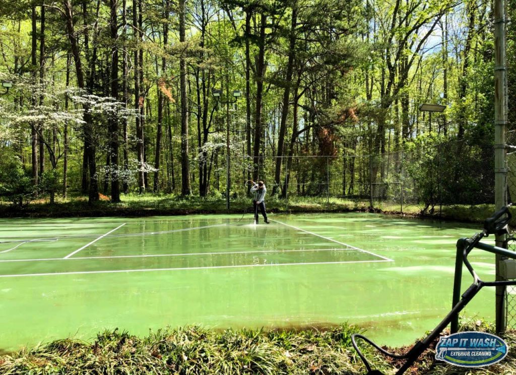 a dirty tennis court pressure washed by zap it wash